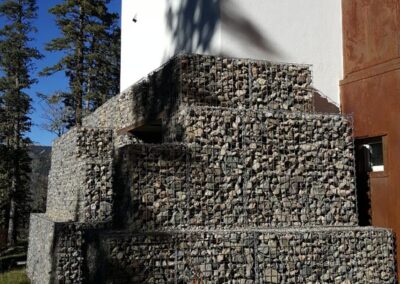 The stone filled gabions along the base of the cabin are designed to provide a protection from deep annual snow fall at the base of the building.